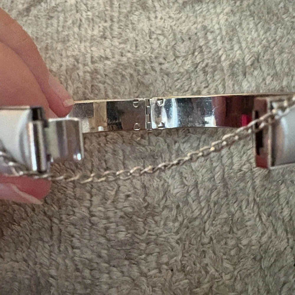 GUC silver tone bangle with safety chain